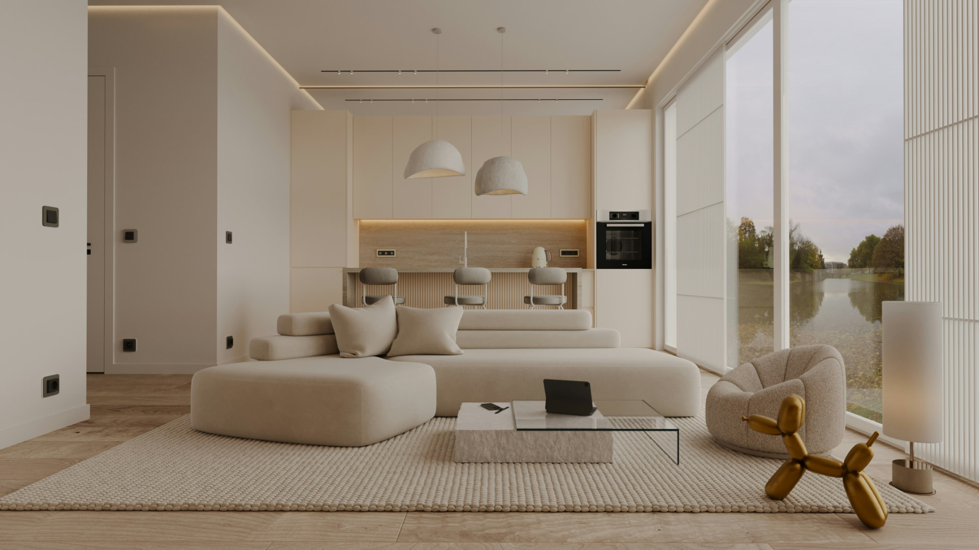 Open living space with a pale modular sofa, integrated kitchen and a window onto a river